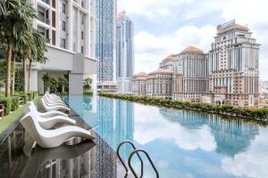 a pool in the middle of a city with tall buildings at The Mews Kuala Lumpur in Kuala Lumpur