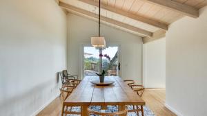 a dining room with a wooden table and chairs at Sonoma Skyhouse by AvantStay Pool Sauna Hot Tub Stunning Valley Views in Sonoma