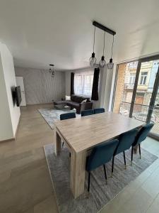 a dining room table and chairs in a living room at Stylish, modern & spacious apartment in Brussels in Brussels