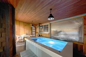 a large swimming pool in a room with a large window at Ganghwa Izba Pension in Incheon