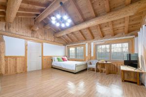 a large living room with a couch and a tv at Ganghwa Izba Pension in Incheon