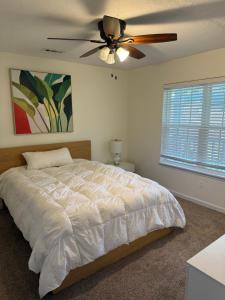 a bedroom with a bed and a ceiling fan at Modern 1- Queen Bed On Quiet Block in Hephzibah