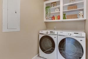 a washer and dryer in a white laundry room at Modern 1- Queen Bed On Quiet Block in Hephzibah