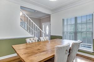 a dining room with a wooden table and chairs at Modern 1- Queen Bed On Quiet Block in Hephzibah