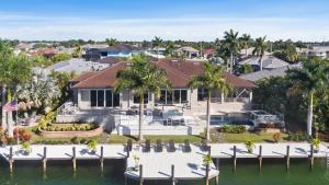 an aerial view of a house on the water at Marco Polo by AvantStay Waterfront 5BDR Pool Spa Fire Pit Walk to Beach in Marco Island