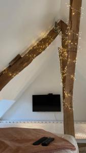 a room with a bed with a tv and lights at Le loft insolite in Lormes