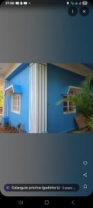 a screenshot of a picture of a blue house at Calangute Pristine Guest House in Calangute