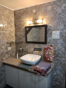 a bathroom with a sink and a mirror on a counter at Shivay family home stay in Varanasi +43 photos
