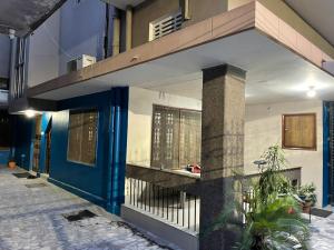 a house with a blue door and a balcony at Shivay family home stay in Varanasi