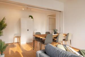 a living room with a wooden table and chairs at Spacious City View Apartment - Prime Location Biel in Biel