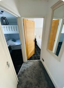 a hallway with a door leading to a bedroom at The Hideaway in Sutton Scotney +4 photos