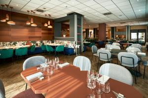 a restaurant with tables and chairs and a bar at Crowne Plaza Padova by IHG in Padova +39 photos