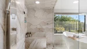 a bathroom with a shower and a tub and a sink at Paso Vista Bella by AvantStay Luxe Group Escape w Wine Country Views in Paso Robles +39 photos