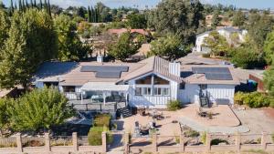 an aerial view of a house with solar panels on the roof at Paso Vista Bella by AvantStay Luxe Group Escape w Wine Country Views in Paso Robles