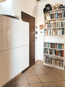 a room with a book shelf with books at Casa Chiara - 2-bedroom apartment in Turin +12 photos