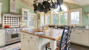 a kitchen with a large wooden table in a kitchen at Catskill Park Farm by AvantStay Huge Yard Fire Pit Near Windham Ski Resort in Prattsville +36 photos