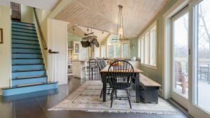a kitchen and dining room with a table and chairs at Catskill Park Farm by AvantStay Huge Yard Fire Pit Near Windham Ski Resort in Prattsville