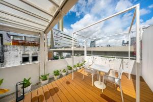 a balcony with a table and chairs on a building at The Lair Bangkok - 3mins walk to ICON SIAM in Bangkok