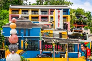 a colorful building with a sign in front of it at Zostel Phuket, Patong Beach Hostel in Patong Beach +33 photos