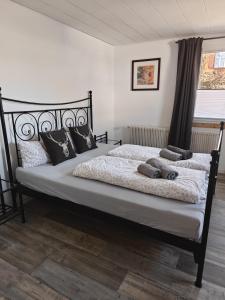 a bedroom with a large bed with pillows on it at Appartement Schöne Schwarzwald Auszeit in Friedenweiler