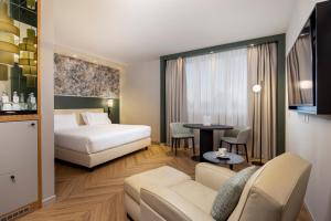 a hotel room with a bed and a table at Crowne Plaza Padova by IHG in Padova