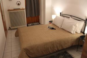 a hotel room with a large bed with white pillows at Fay's Apartments II in Arachova