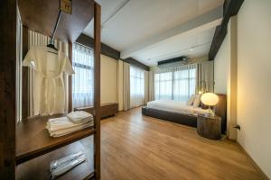 a bedroom with a bed and a dresser in a room at The Lair Bangkok - 3mins walk to ICON SIAM in Bangkok +201 photos