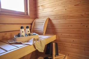 a wooden room with bottles of wine in it at Aurora River View 3-Bedroom Apartment by BookLapland in Rovaniemi +10 photos
