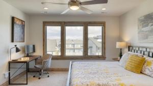 a bedroom with a bed and a desk and a window at Blue Skies Lakeside Family-Friendly Getaway w Hot Tub BBQ in Heber City