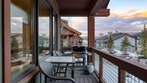 a porch with chairs and a grill on a balcony at Blue Skies Lakeside Family-Friendly Getaway w Hot Tub BBQ in Heber City
