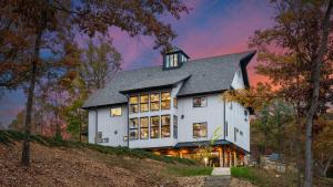 a large white house on top of a hill at The Grand on Greenbay-7 bedrooms Sleeps 20 Modern new build in Mooresville