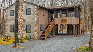ein Haus, zu dem eine Treppe hinaufführt in der Unterkunft Atlas Point Lodge Sauna Fireplaces Kayaks Lakes Pet-Friendly Yard in Pocono Lake