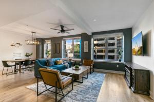 a living room with a blue couch and a table at California Building in New Orleans
