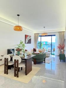 a living room with a couch and a table and chairs at executive fully furnished apartments with luxurious facilities which features a breathtaking city views and close proximity to major shopping malls thus offering a high end lifestyle in Nairobi