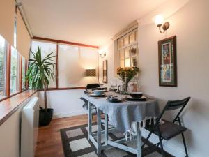 a dining room with a table and chairs at Minn's Cottage in Snainton