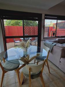a living room with a glass table and chairs at Beautiful Holiday Home in Gold Coast