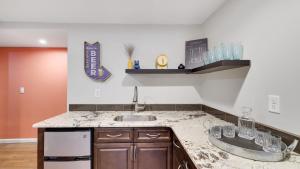a kitchen with a sink and a counter top at Moshannon Tree-Lined Pocono Retreat w Hot Tub Firepit Pool Table in Pocono Lake +80 photos