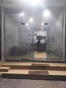 a person standing in a display window of a store at Orange Line Hotel in Dargai