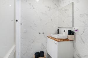 a white bathroom with a sink and a mirror at Casa sofia in Argana +36 photos