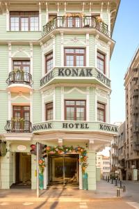 a building with a konark hotel on a street at Konak Hotel Taksim in Istanbul