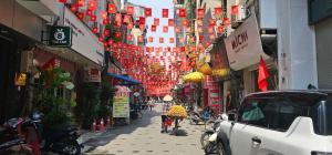a street in an asian city with signs on buildings at Bu studio 46 Nam Ngư in Hanoi