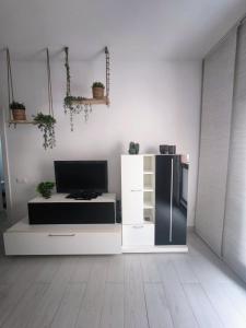 a living room with a black and white refrigerator at Golf Villa 18 Los Abrigos in Los Abrigos +21 photos