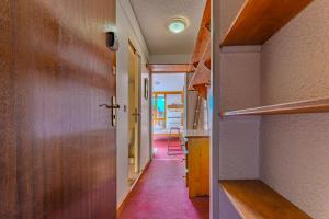 an empty hallway with a door and a hallway with a hallway at Hauts de Vanoise 3 personnes Coeur Village in Val Thorens