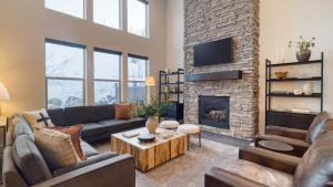 a living room with a couch and a fireplace at Abigail Drive Year-Round Retreat with Hot Tub Near Park City Adventures Skiing in Heber City
