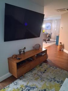 a living room with a large flat screen tv on a wall at Waterfront Cottage in Marco Island