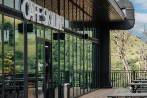 a building with a view of a mountain through the windows at Krystal Bakuriani resort hotel 202C in Bakuriani