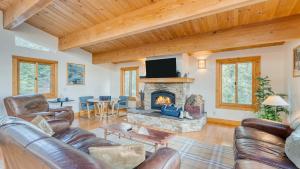 a living room with a couch and a fireplace at Tahoe Timber by AvantStay Beach Lake Access in Homewood