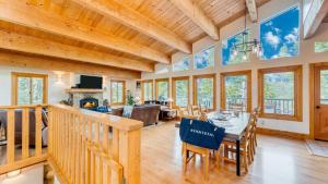 a dining room and living room with a table and chairs at Tahoe Timber by AvantStay Beach Lake Access in Homewood