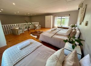 a large bedroom with two beds and a couch at Stella Maris Cabanas in Ponta do Ouro