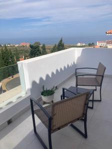 two chairs and a table on a balcony with a view at SUNLIGHT Spain in Manilva
